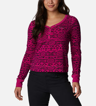 Woman in a pink and black printed top.