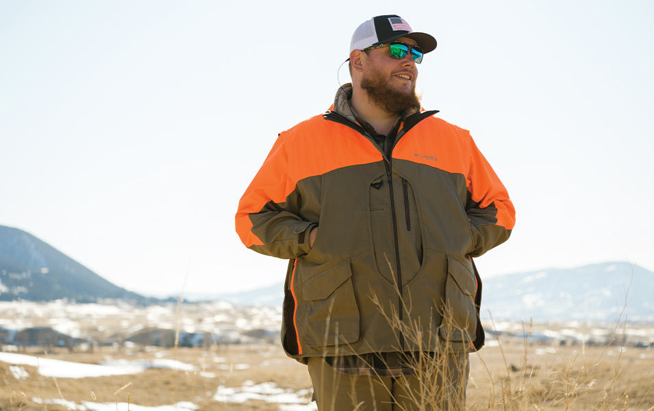 Luke Combs standing in a Montana field. 