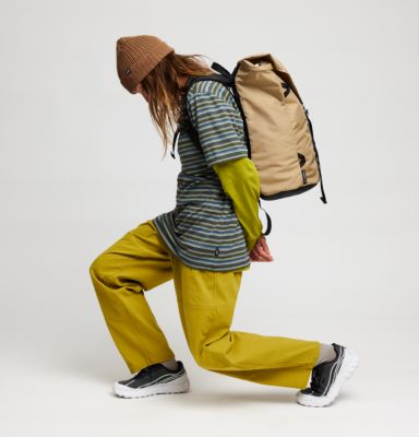 A vibey studio shot of a female climber bending forward in the Rockrydge pants.