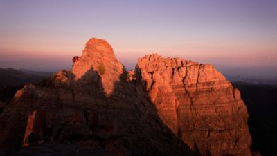 MHW Athlete Ted Hesser running at dusk on a trail ridge.