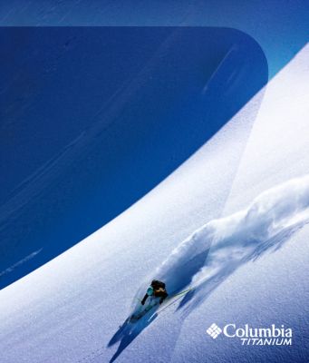 Skier turning down a steep powder slope.