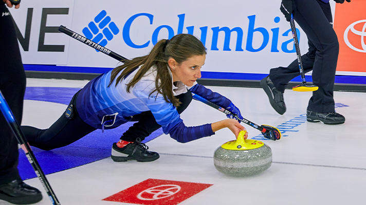 Close-up of two USA curlers in Columbia gear. 