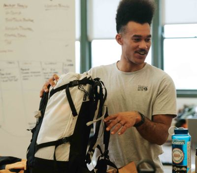 Bryce sharing feedback on the AMG pack with the equipment team at Mountain Hardwear HQ.