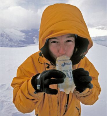 Sue Nott sips from a beer in the high alpine.