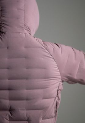 Detail shot of the Super/DS™ Stretchdown Hooded Jacket in the studio being actively stretched out