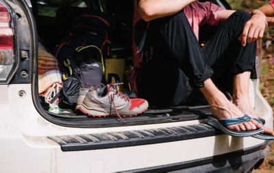 Person wearing flip flops in an SUV. 