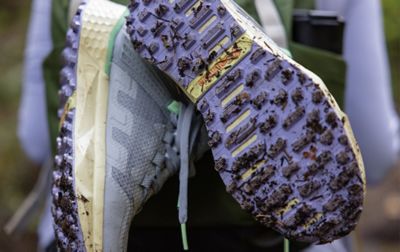 The muddy treads of a pair of Columbia Sportswear hiking shoes.