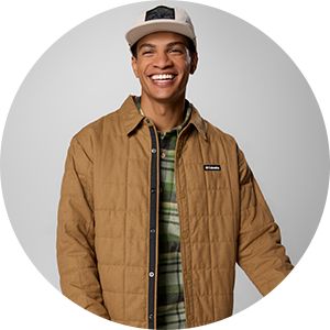 A man smiling in fall layers.