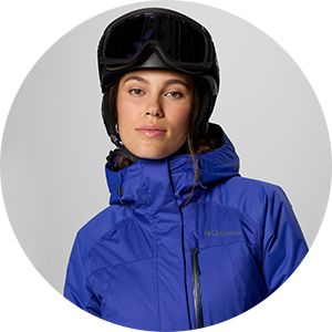 A woman geared up in her ski jacket, helmet, and goggles.