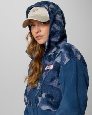A woman in a cozy blue fleece with the hood up.