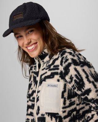 Woman in a fleece and ballcap.