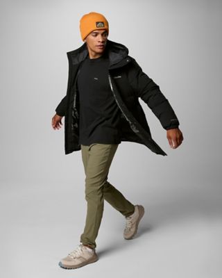 A man walking in an outdoor outfit.