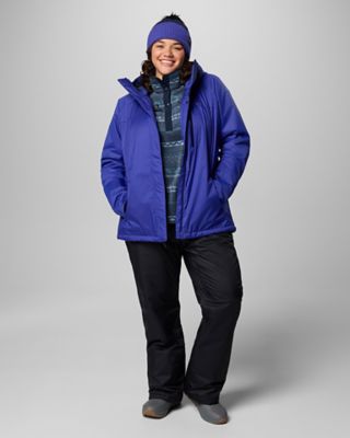 A woman in a casual looking ski outfit.