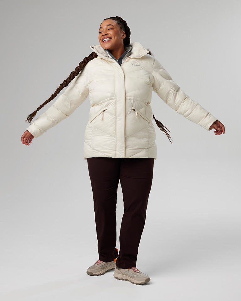 Outfit 5: White puffer jacket, black pants, tan hiking shoes.