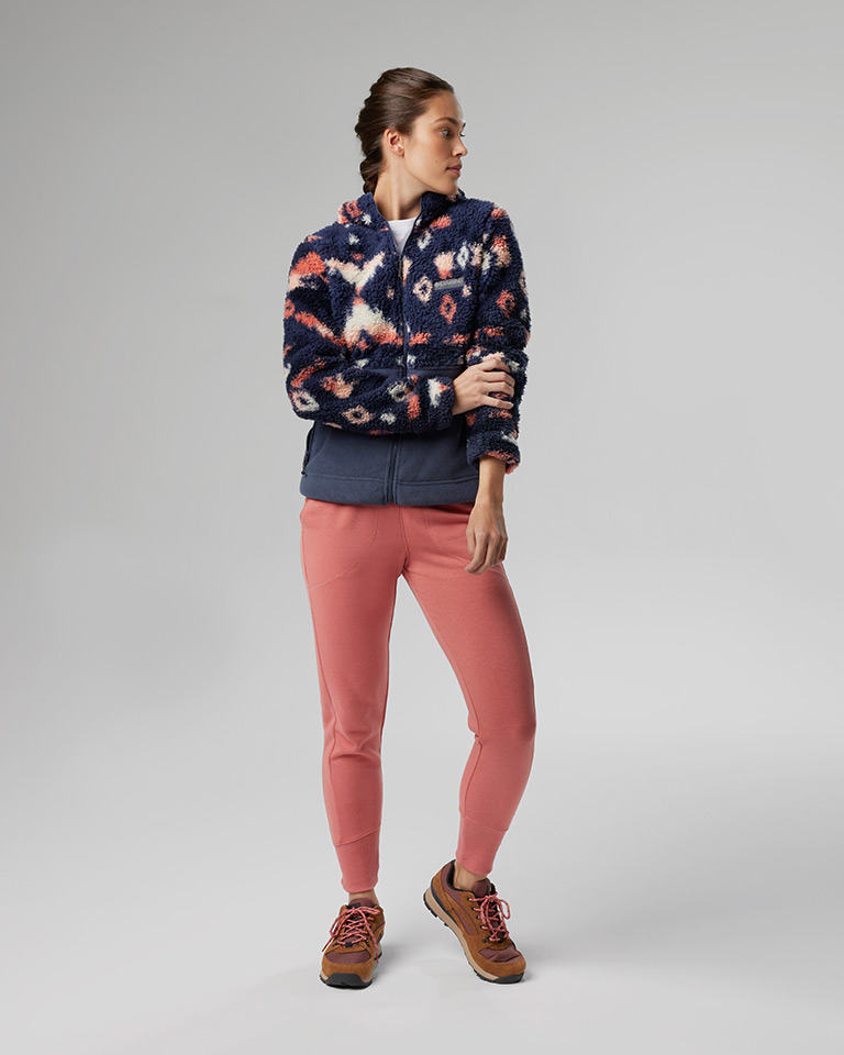 Outfit 4: Plush sherpa fleece in a bold southwestern-style print, white tee, coral pants, tan hiking shoes.