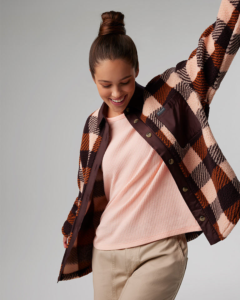 Outfit 2: brown and pink plaid print fleece jacket, pink top, khaki pants.