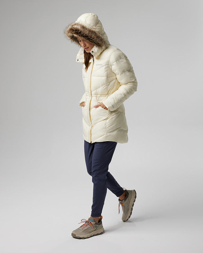 Outfit 8: white fitted puffer parka, blue pants, tan hiking shoes.