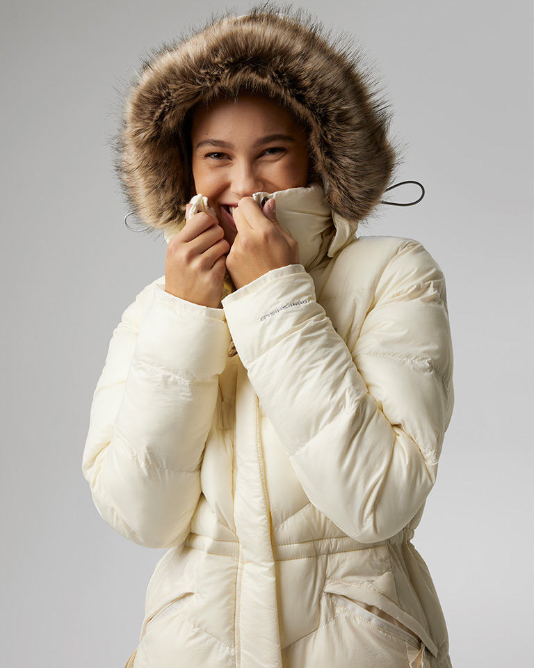 Outfit 8: model bundled up in a white fitted puffer parka.