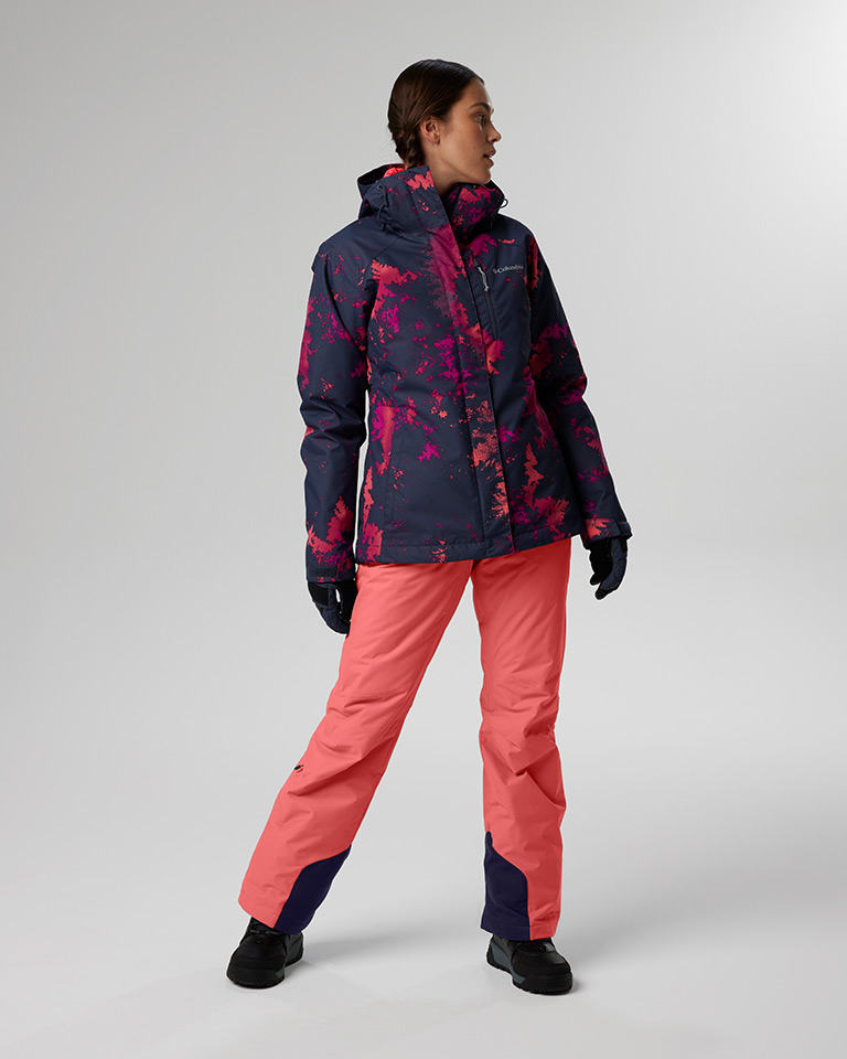Outfit 9: High-contrast patterned Interchange jacket with puffer, coral snow pants.