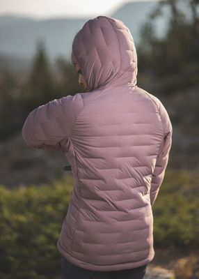 MHW ambassador Genevive Walker turned around and stretching wearing the Super/DS™ Stretchdown Hooded Jacket outside of Salt Lake City
