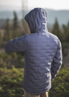 MHW ambassador Cody Kaemmerlen turned around and stretching wearing the Super/DS™ Stretchdown Hooded Jacket outside of Salt Lake City

