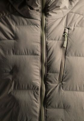Detail shot of the Women's Super/DS™ Stretchdown Parka front zip, logo and fabric details