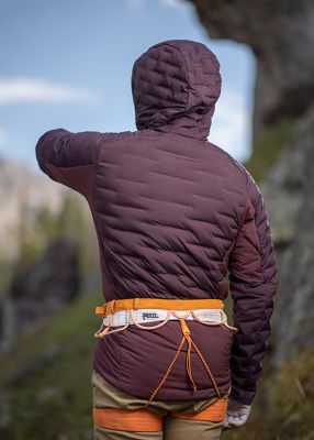 MHW employee turned around and stretching wearing the Men's Stretchdown™ Hybrid Hoodyoutsideoutside of Salt Lake City
