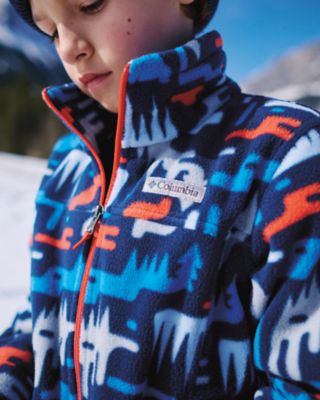 A kid wearing a cozy printed fleece.