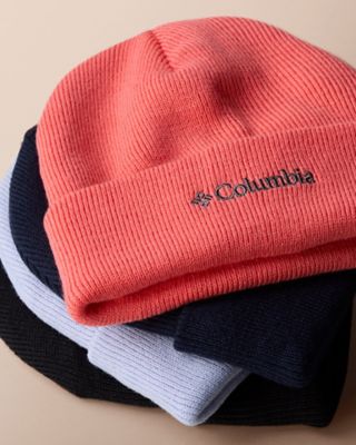Colorful beanies stacked on top of each other. 