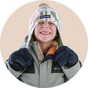 A close-up of a kids wearing a Columbia hat and jacket.