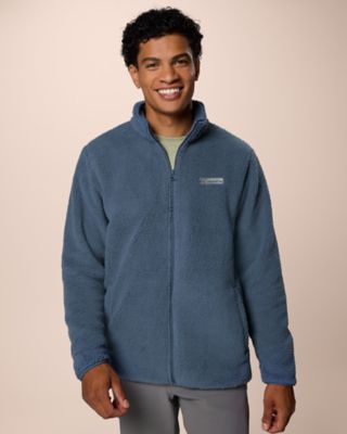A man smiling wearing a soft, plush fleece.