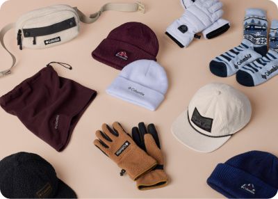 A laydown of multiple stocking stuffers like slippers, mugs, and gloves.