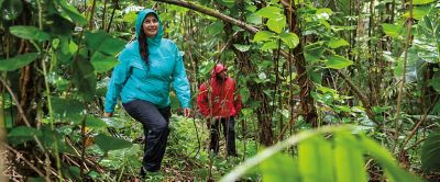 Man and woman hiking in the rain. 