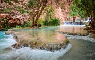 Vivid blue-green water flows along Havasu Creek as it cuts through the Havasu Indian Reservation enroute to Havasu Falls.