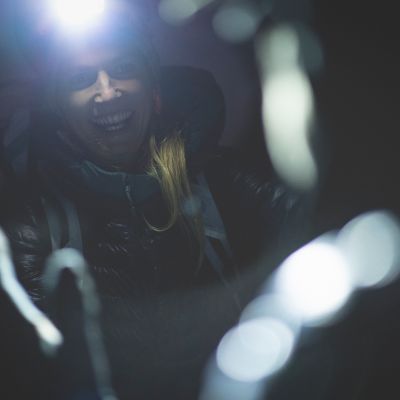 Headlamps on, ready to roll, wearing the Ghost Whisperer Down Jacket