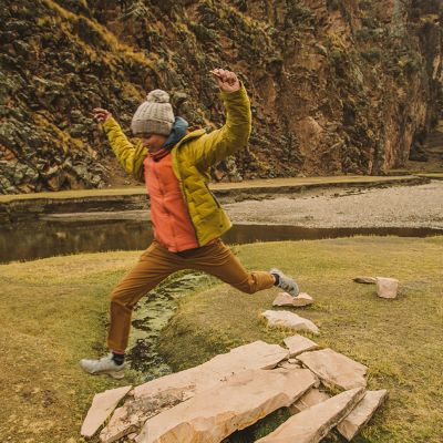 Jumping over a small creek in Peru wearing the Super/DS hooded jacket, over many other layers to keep warm.
