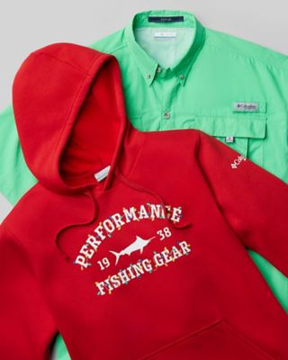 A laydown of a holiday-themed PFG hoodie and a PFG fishing shirt.
