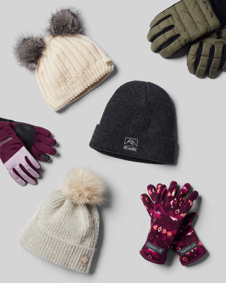 A laydown of cute kids snow hats and gloves.