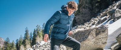 A man standing on a rocky slope. 