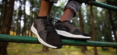Close-up of black sneakers outdoors.