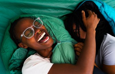 Smiling in sleeping bags in the tent.