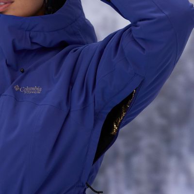 Close-up of a woman buttoning a Silver Ridge shirt. 