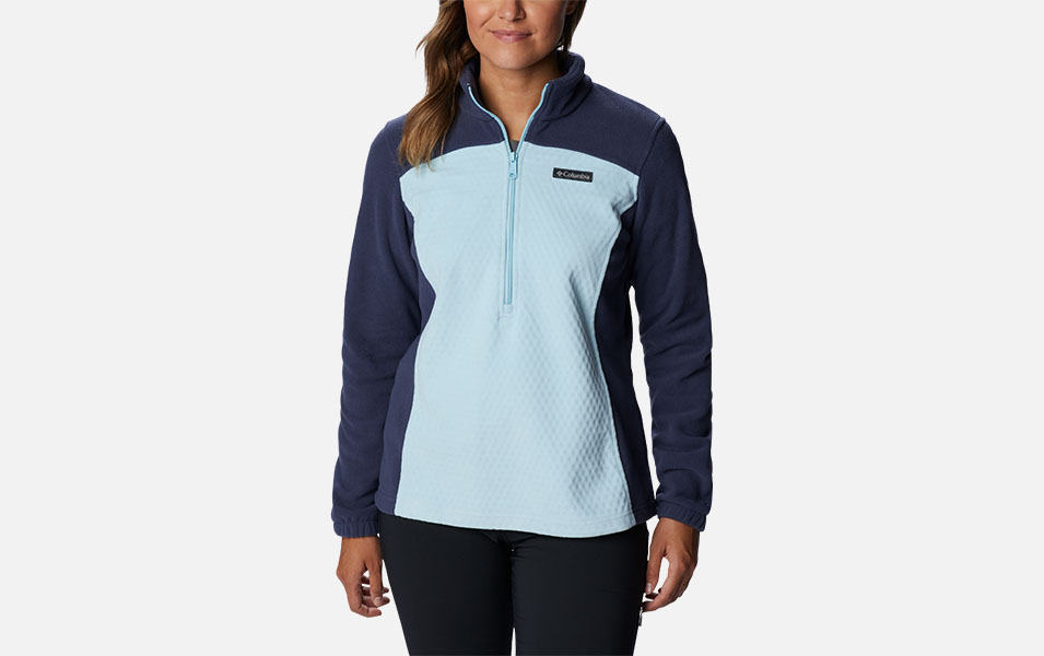 A product image of a woman wearing Columbia Sportswear’s Overlook Trail Half Zip Pullover against a white background.