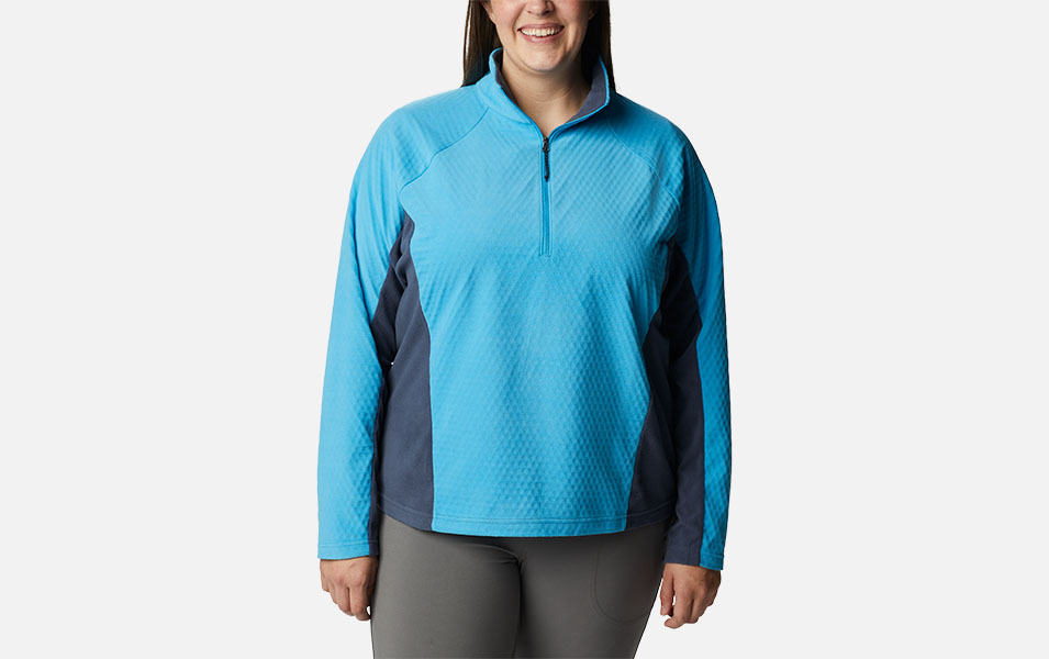 A product image of a woman wearing Columbia Sportswear’s Overlook Pass Half Zip against a white background. 