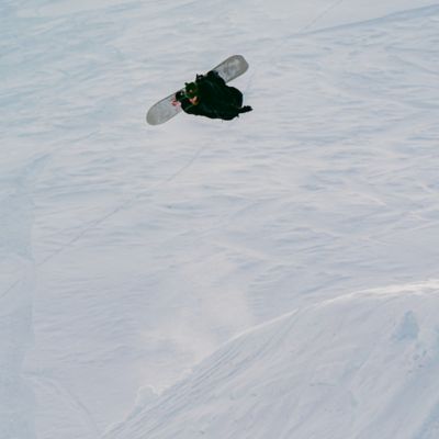 Alek Oestreng ripping on a snowboard.