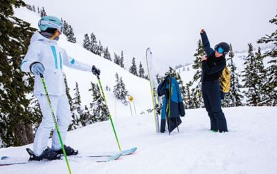 Skiers getting putting on gear. 