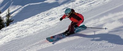 Woman skiing down a snowy mountain. 