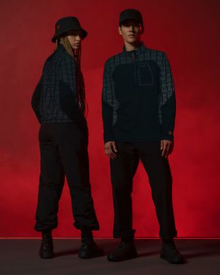Man and woman in a Vader tech half zip