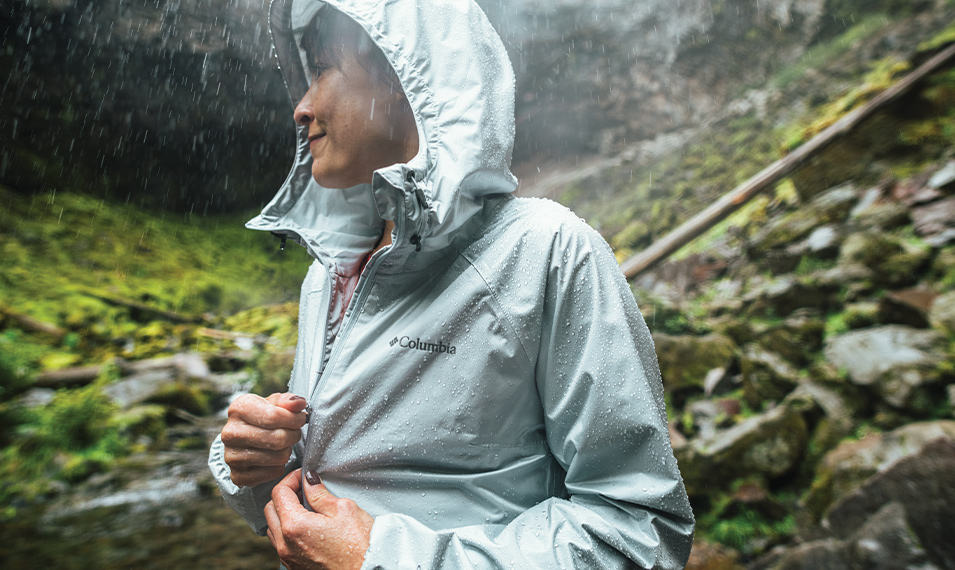 Woman in a Columbia jacket on a rainy hike in the Pacific Northwest. 