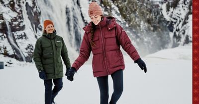 Woman and man exploring a snowy wilderness
